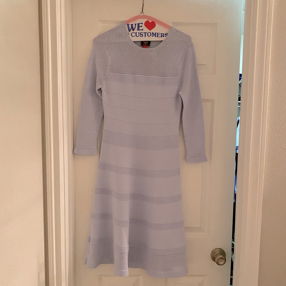 Very light blue, three quarter sleeve dress. Fitted in middle, A line